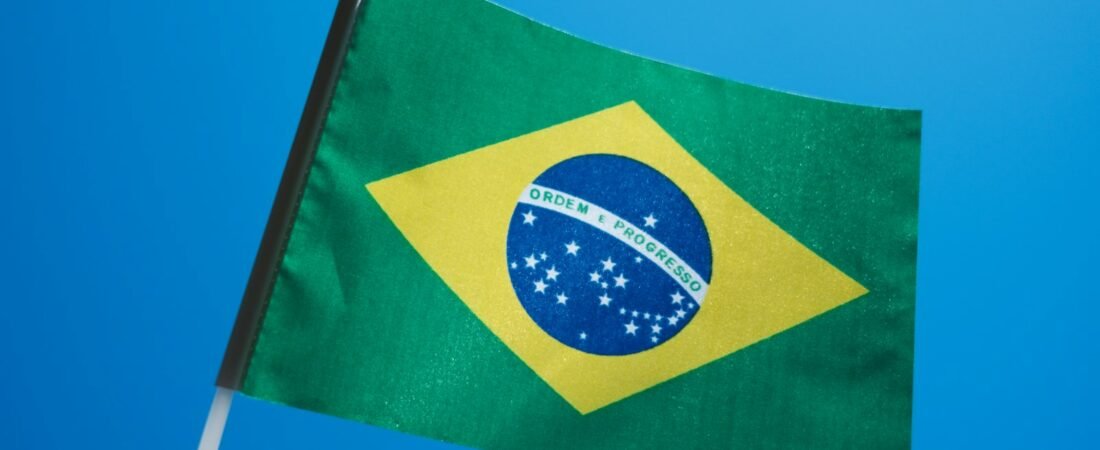 The flag of Brazil against a blue sky